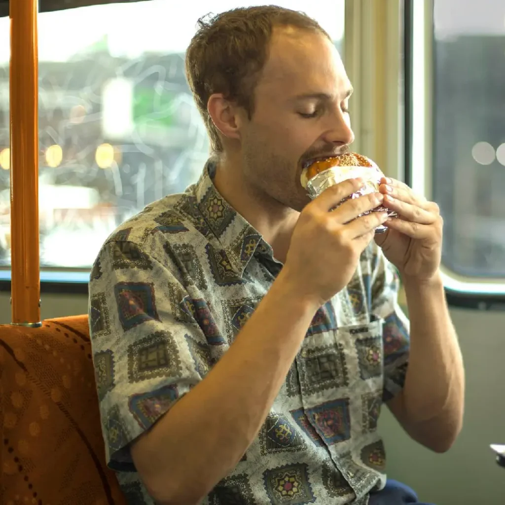 eating burger in a Mr. Burger truck tram